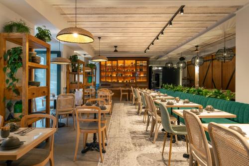 a restaurant with wooden tables and chairs and books at Pestana Rua Augusta Lisboa in Lisbon