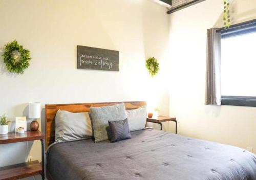 a bedroom with a bed and a sign on the wall at Rivers Edge Lofts - Unit 7 in Niles
