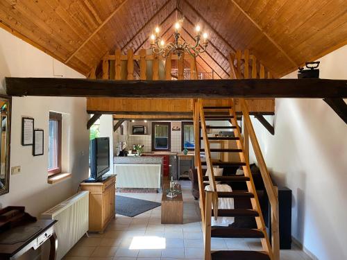 a living room and kitchen with a staircase in a house at Zum Schafstall in Hünxe