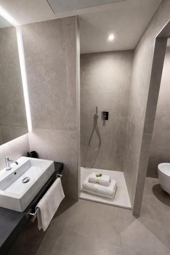 a bathroom with a sink and a shower at R Platano House in Como
