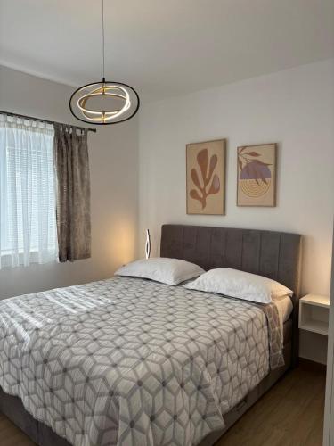 a bedroom with a bed and a large window at Studio Apartments Lovrić in Vodice