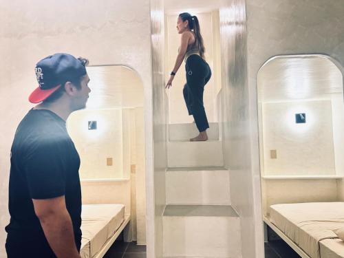 a man and a woman standing on stairs in a room at Poddwell Siquijor in San Juan