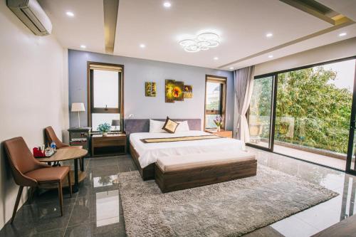 a bedroom with a bed and a large window at Villa FLC Sầm Sơn Thanh Hoá in Sầm Sơn