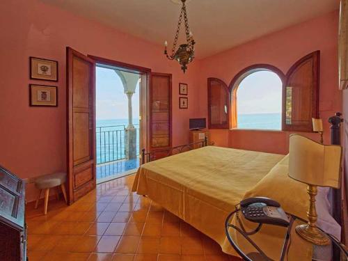 a bedroom with a bed with a phone on it at Villa Scarpariello Relais in Ravello
