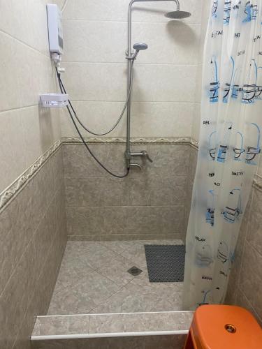a shower with a shower curtain in a bathroom at GUM University Apartment in Ulaanbaatar