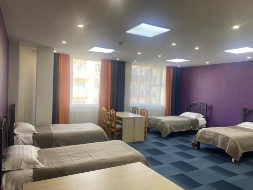 a hospital room with three beds and a table at GUM University Apartment in Ulaanbaatar