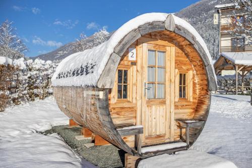 a wooden cabin with a round roof in the snow at EuroParcs Hermagor - Nassfeld in Hermagor