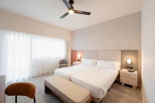 a hotel room with a bed and a ceiling fan at Hotel RH Royal - Recommend for adults in Benidorm