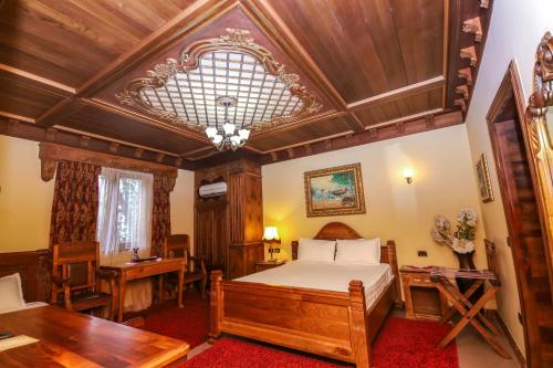 a bedroom with a bed and a wooden ceiling at Brilant Antik Center in Tirana