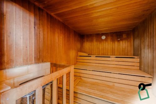 an empty sauna with wooden walls and wooden floors at Hotiday Malcesine Garda in Malcesine