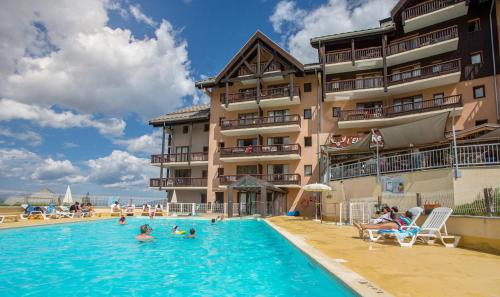 a swimming pool in front of a hotel at Résidence Pierre & Vacances Le Thabor in Valmeinier