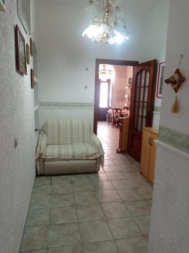 a living room with a couch sitting on a tile floor at Casa Valia in Carloforte