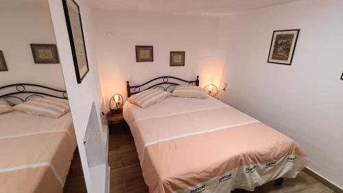 a bedroom with two beds and two lamps in it at Summer Dream in Poros