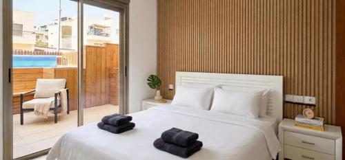 a bedroom with a bed with two towels on it at Amdar Holiday Apartments in Eilat