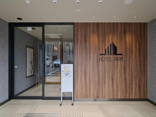 a glass door with a hotel fly sign on it at Hotel ARM ObihiroEkimae in Obihiro