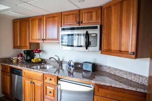 a kitchen with a sink and a microwave at Newport Bay Club and Hotel in Newport