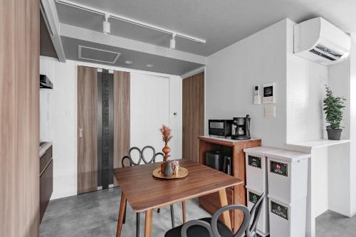 a kitchen and dining room with a wooden table and chairs at Gran Hills in Chitose