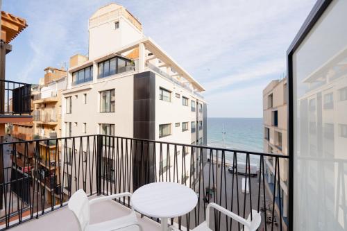 a balcony with a table and a view of the ocean at Estudios RH Sol in Benidorm
