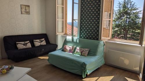 a living room with a couch and a chair at Les Meublés des Pierres Dorées - Gite de charme pour groupe in Theizé