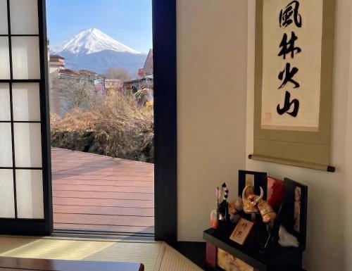 a door with a view of a snow covered mountain at Holiday home Furinkazan 風林火山 in Fujikawaguchiko