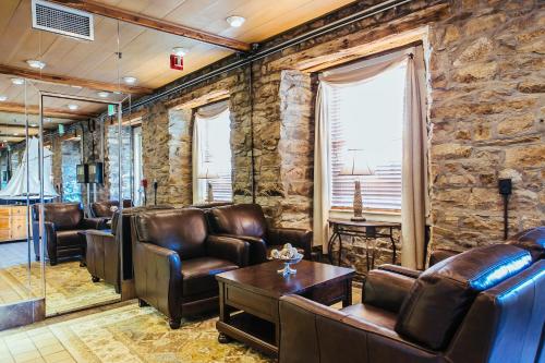 a waiting room with leather furniture and a stone wall at Newport Bay Club and Hotel in Newport