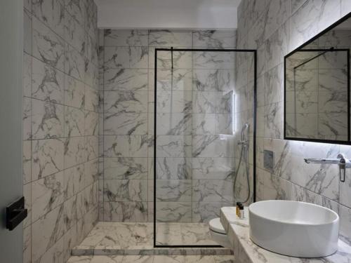 a bathroom with a tub and a sink and a shower at Villa Christy in Psarou