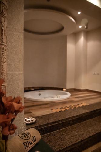 a bathroom with a tub in the middle of a room at Rivoli Suites in Hurghada