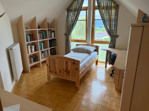a bedroom with a bed and a large window at Haus am Ring in Spielberg