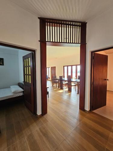 a room with two doors and a living room with a table at Alpha bungalow in Kandy