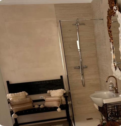 a bathroom with a shower and a sink and towels at Casa de la luz in Cartagena