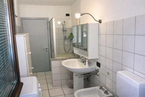 a bathroom with a sink and a toilet and a mirror at Ca' del Maharajà in Gargallo
