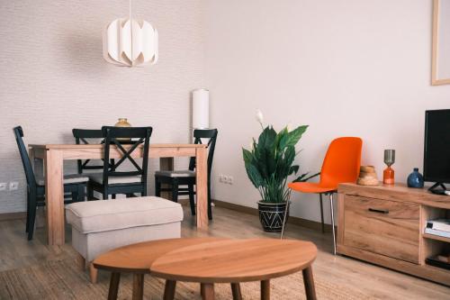 a living room with a dining room table and chairs at Quinta das Conchas Apartment by Trip2Portugal in Lisbon