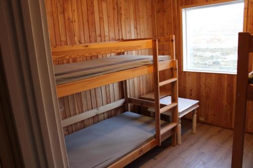 a room with two bunk beds in a cabin at Gjesvaer Fishing in Gjesvær