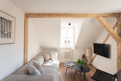 a living room with a couch and a table at Boutique Charme Apartments Küferstr 10-12 in Baden-Baden