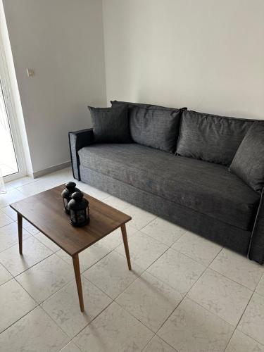 a living room with a couch and a coffee table at Seaside Paralio Apartment in Astros