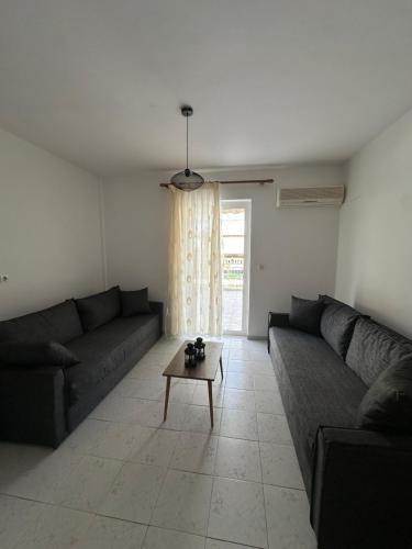 a living room with two couches and a coffee table at Seaside Paralio Apartment in Astros