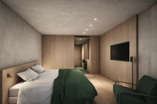a bedroom with a bed and a flat screen tv at Farmhouse Milla Montis in Maranza