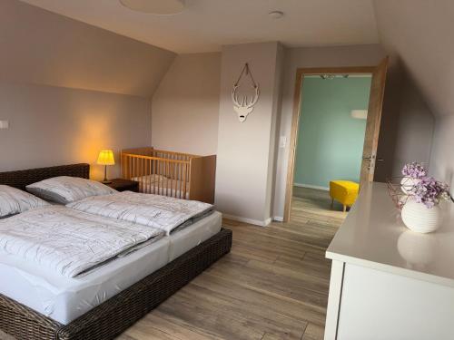 a bedroom with a bed and a hallway with a door at Harzhaus Ida in Elbingerode