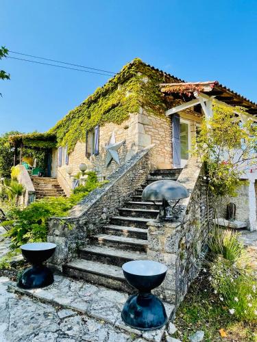a brick house with stairs leading up to it at Maison Quercus in Vaylats