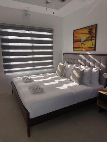 a large bed in a room with a large window at Philla D Afrique Resort in Inopacan