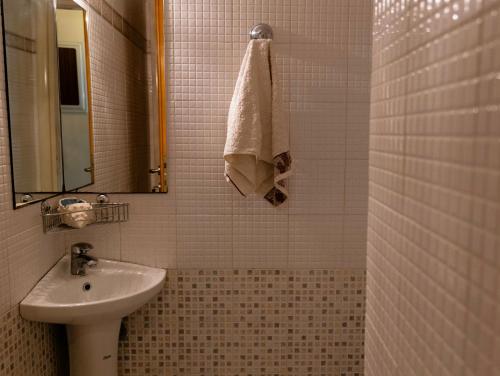 a bathroom with a sink and a mirror and a towel at SUMMER Home in Agios Nikolaos