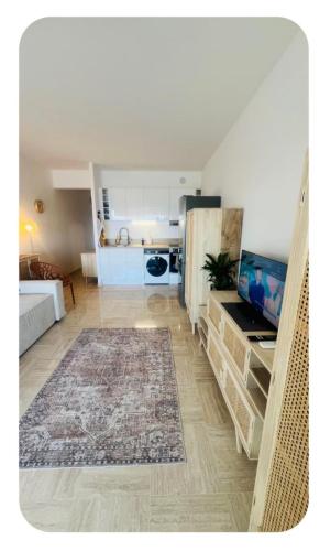 a room with a kitchen and a living room at Casa Monica Nizza VILLENEUVE-LOUBET in La Celle-sous-Gouzon