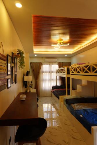 a room with two bunk beds and a table at Balay Buenavista in Magdalena