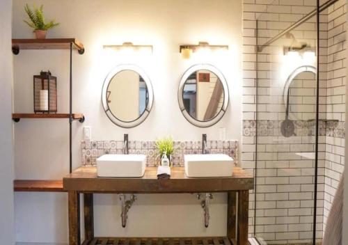 a bathroom with two sinks and two mirrors at Rivers Edge Lofts - Unit 5 in Niles
