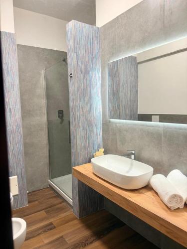a bathroom with a sink and a mirror at Hotel Palombella & Restaurant in Frosinone