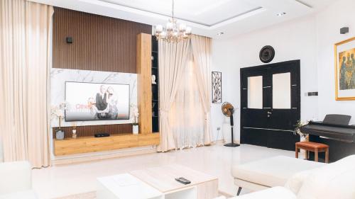 a living room with a television and a piano at 3Apartments in Lagos