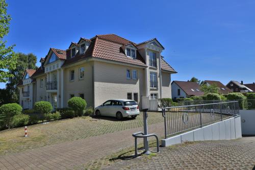 a white car parked in front of a house at 2 Zimmer Appartement Poseidon in Boltenhagen