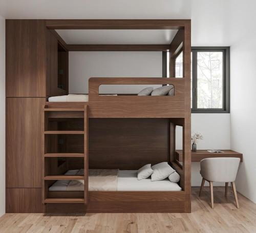 two bunk beds in a room with a desk at The Dang's Home in Lao Cai in Pho Mới