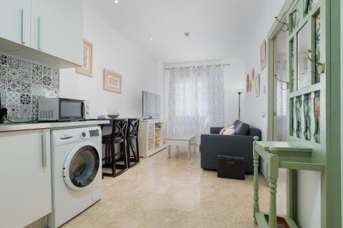 a kitchen and a living room with a washing machine at LuxSevilla Apartment Piscina in Bormujos