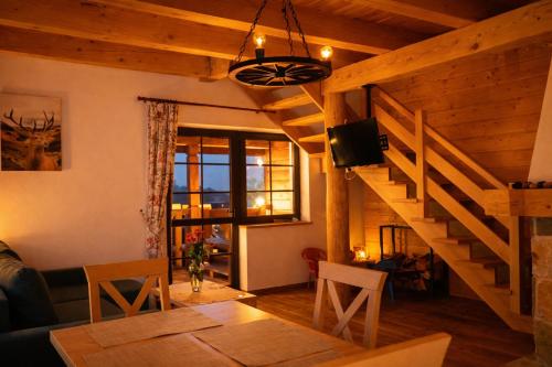 a living room with a staircase and a television at Dom u Braci in Wołkowyja